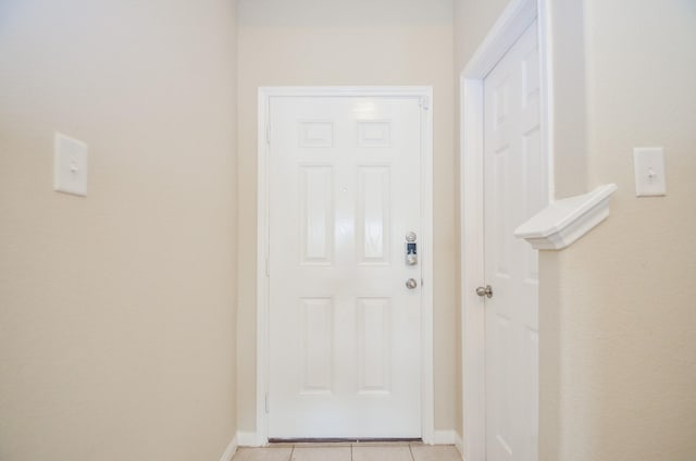 doorway to outside featuring light tile patterned flooring