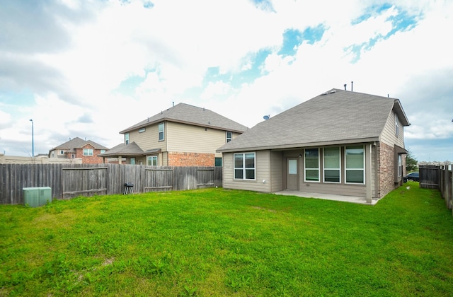 back of property featuring a lawn and a patio