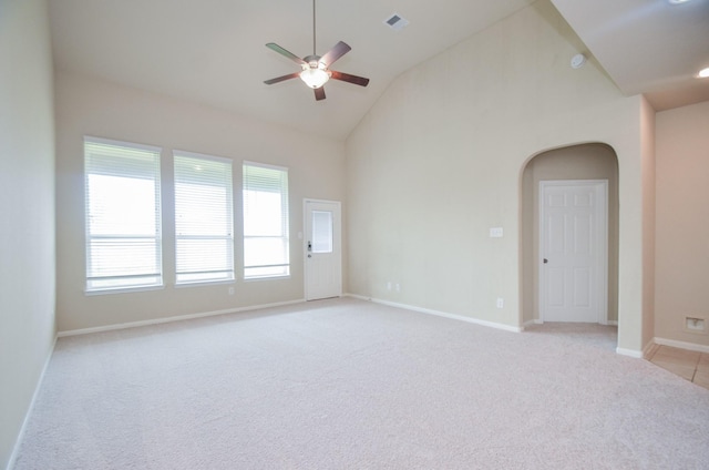 spare room featuring high vaulted ceiling, ceiling fan, and light colored carpet