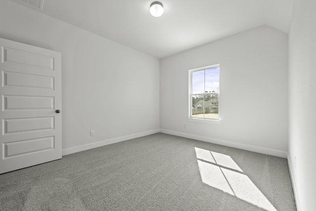 unfurnished room with vaulted ceiling and light carpet