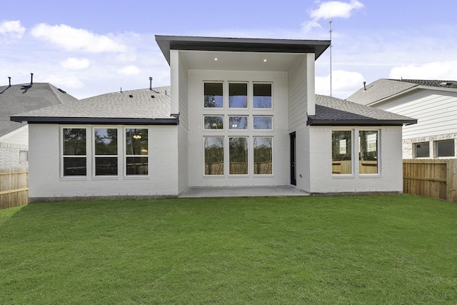 back of property featuring a lawn and a patio area