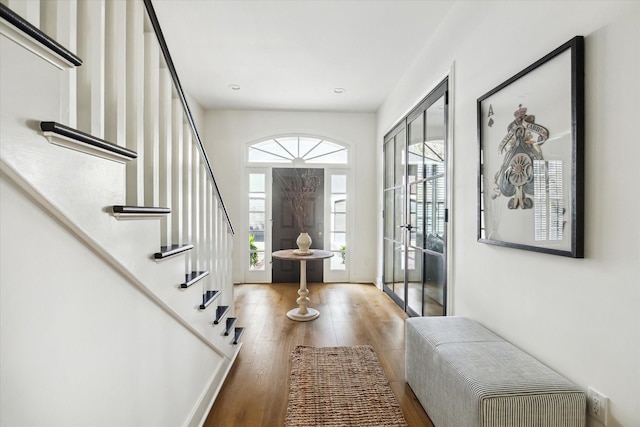 foyer entrance with hardwood / wood-style flooring and a wealth of natural light