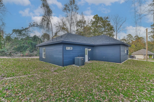 back of house featuring a yard and central air condition unit