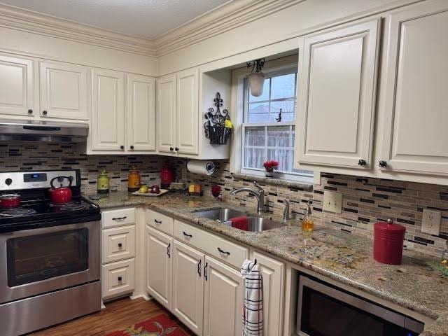 kitchen with sink, stainless steel appliances, and white cabinetry