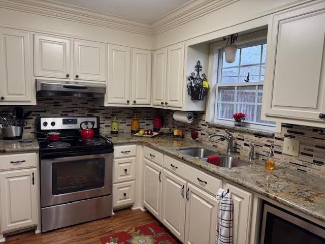 kitchen featuring sink, stainless steel electric range oven, and white cabinets