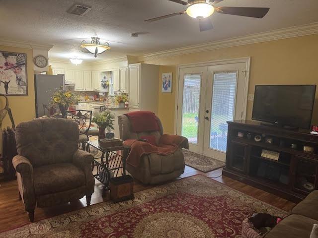 living room with hardwood / wood-style flooring, ornamental molding, french doors, and ceiling fan