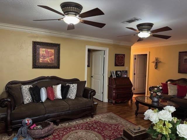 living room featuring hardwood / wood-style flooring, ornamental molding, and ceiling fan