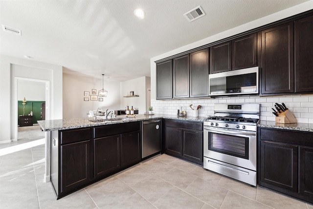 kitchen with visible vents, appliances with stainless steel finishes, pendant lighting, and a sink