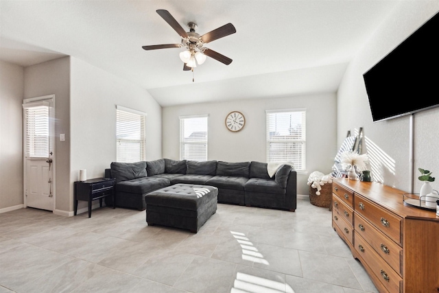 living room with light tile patterned floors, ceiling fan, baseboards, and vaulted ceiling