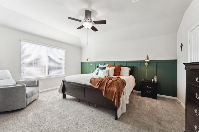 bedroom with a ceiling fan, light carpet, and baseboards