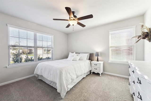 bedroom featuring ceiling fan, baseboards, and light colored carpet