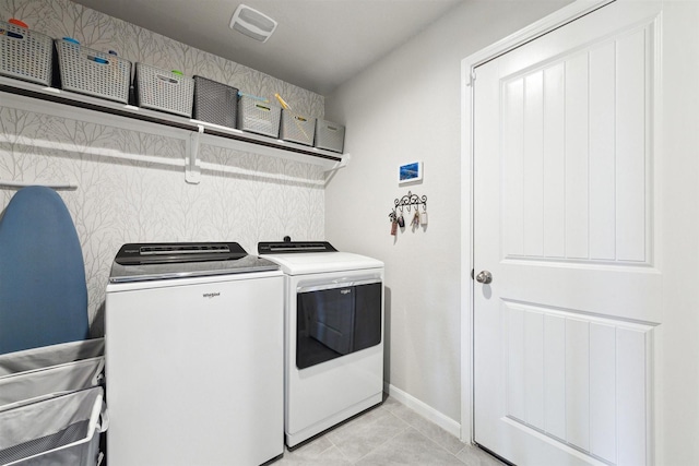 laundry room with light tile patterned floors, laundry area, separate washer and dryer, visible vents, and baseboards