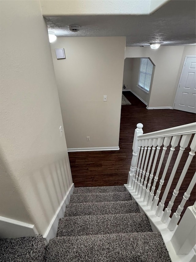 stairs featuring hardwood / wood-style floors