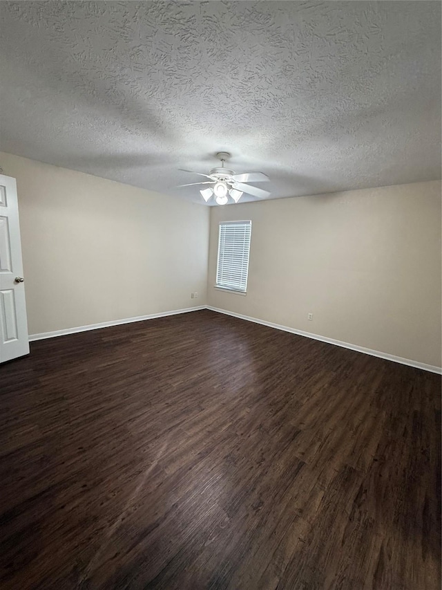 empty room featuring a textured ceiling, dark hardwood / wood-style floors, and ceiling fan