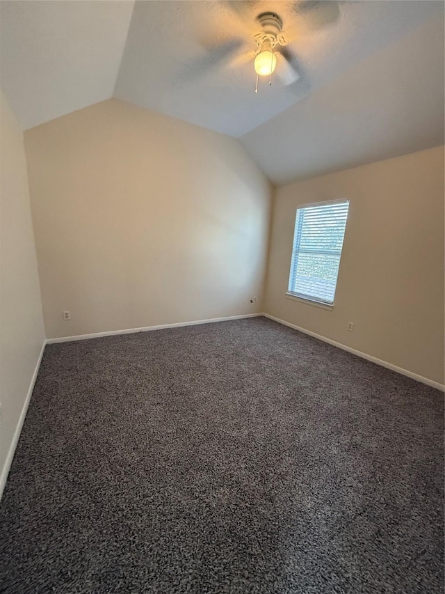 interior space featuring vaulted ceiling, ceiling fan, and carpet flooring