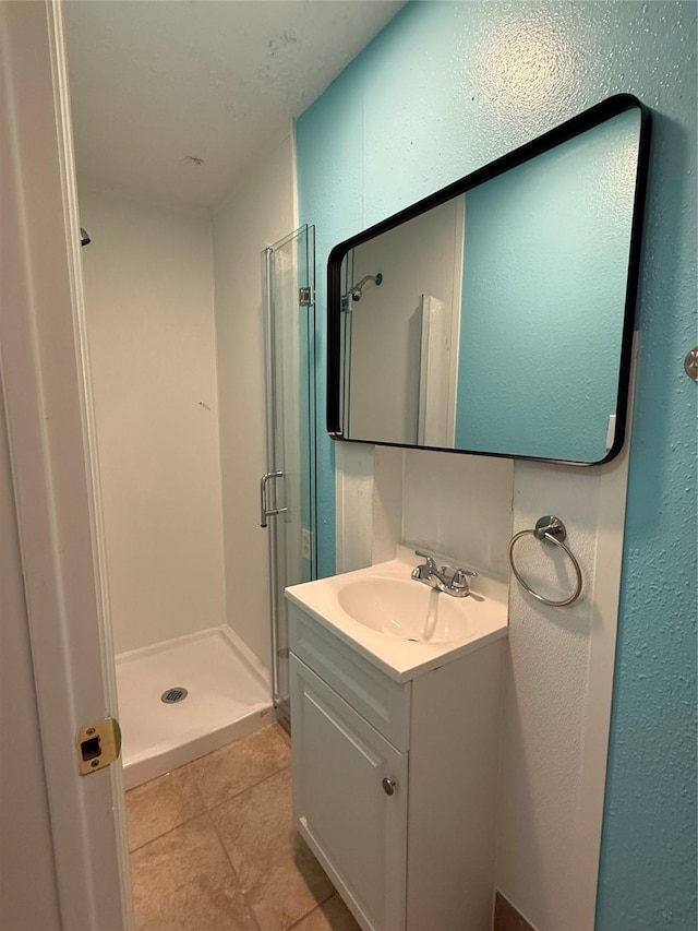 bathroom with vanity, tile patterned floors, and a shower