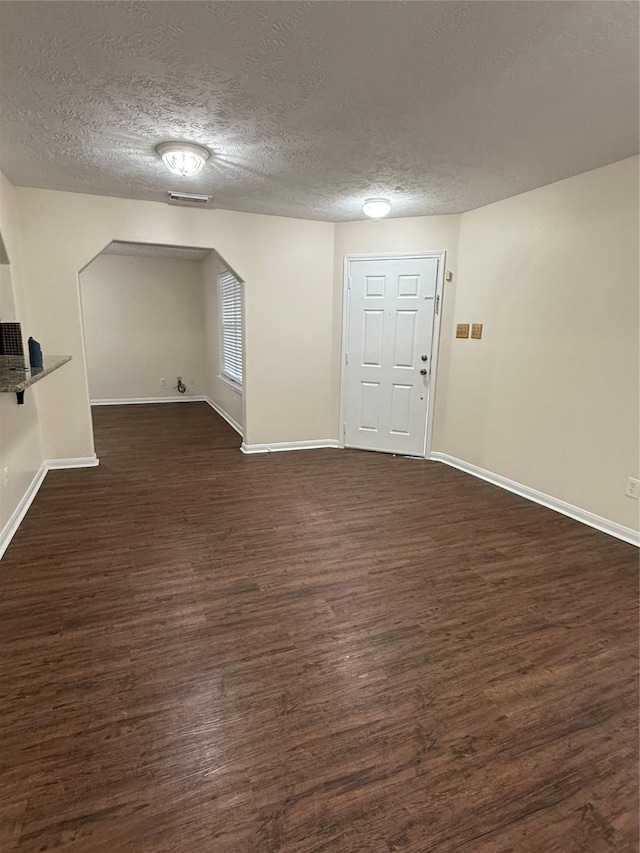 interior space with dark hardwood / wood-style floors and a textured ceiling