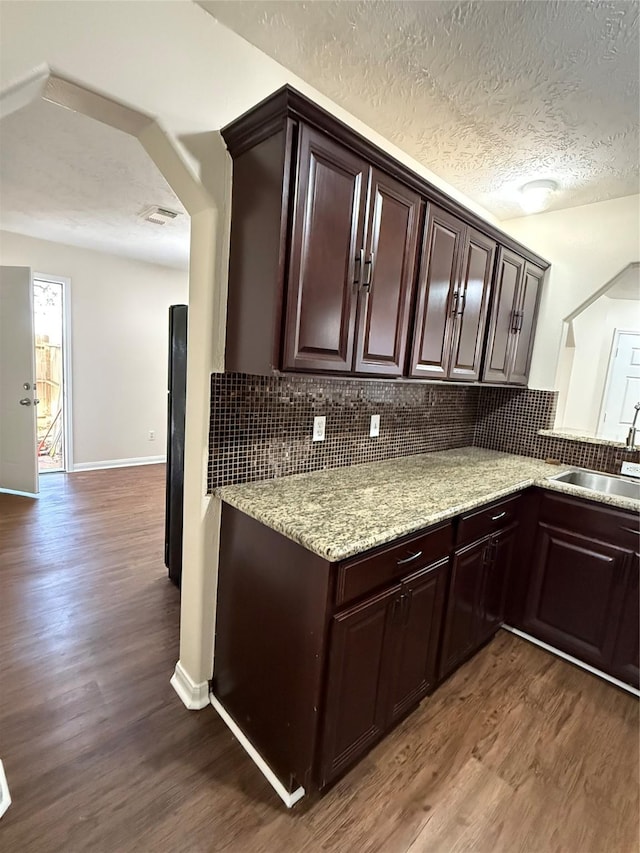 kitchen featuring sink, hardwood / wood-style floors, and decorative backsplash