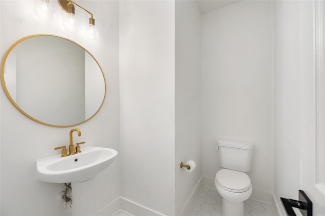 bathroom with tile patterned flooring and toilet