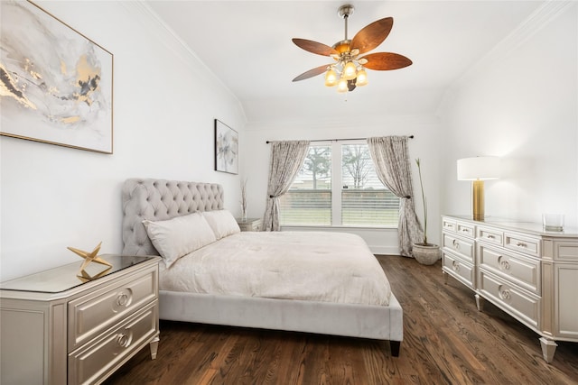 bedroom featuring dark wood-type flooring, crown molding, and ceiling fan