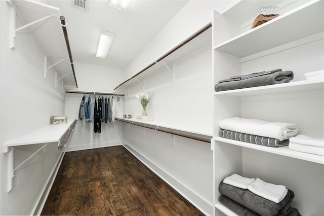 spacious closet with dark hardwood / wood-style floors