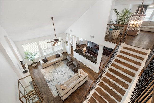 living room featuring ceiling fan, dark hardwood / wood-style floors, and lofted ceiling