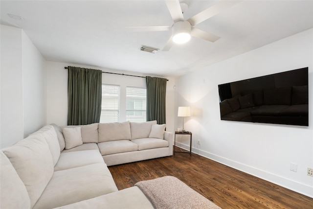 living room with dark hardwood / wood-style flooring and ceiling fan