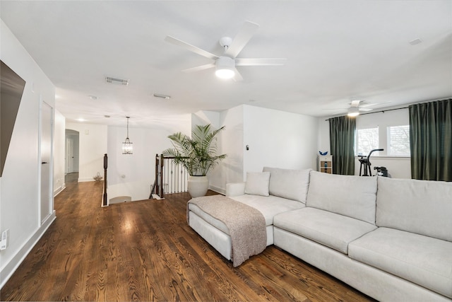 living room with ceiling fan and dark hardwood / wood-style floors