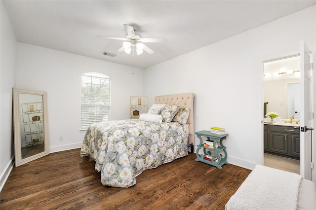 bedroom with sink, connected bathroom, dark hardwood / wood-style floors, and ceiling fan