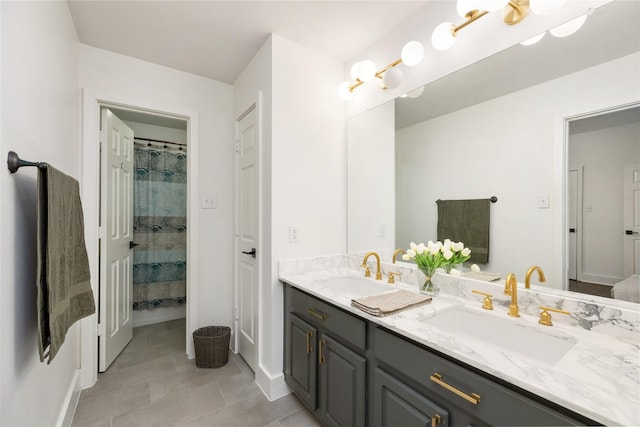 bathroom featuring tile patterned flooring, vanity, and walk in shower