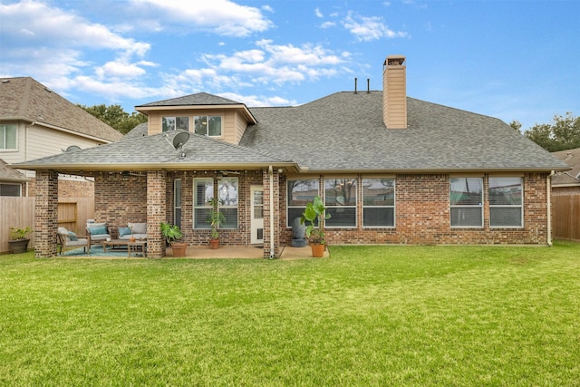 back of property featuring a lawn, outdoor lounge area, and a patio area