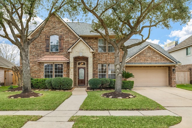 front of property featuring a garage and a front yard