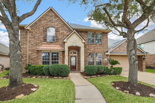 front facade featuring a front yard and a garage