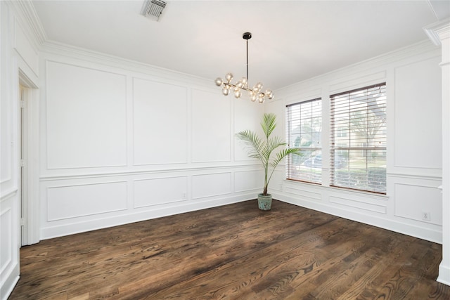 unfurnished dining area with dark wood-type flooring, crown molding, and a notable chandelier