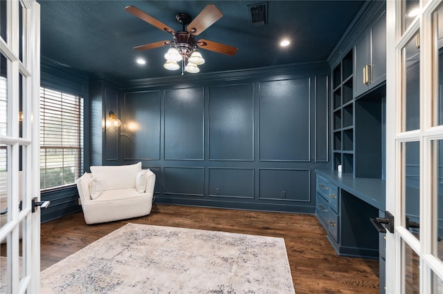 sitting room featuring ceiling fan, dark wood-type flooring, crown molding, and french doors