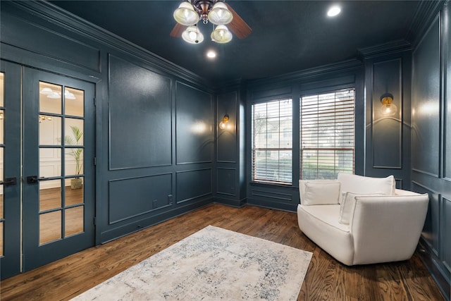 sitting room with ceiling fan, crown molding, french doors, and dark hardwood / wood-style floors