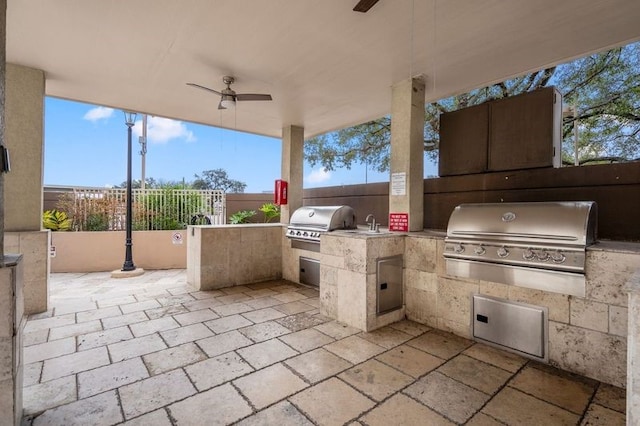 view of patio with area for grilling, ceiling fan, and grilling area