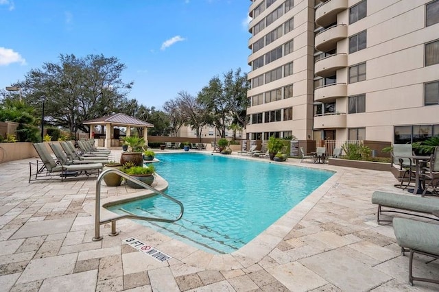 view of swimming pool with a patio and a gazebo