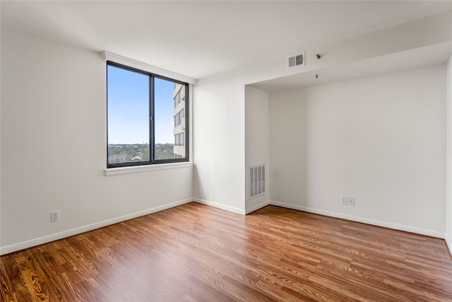 spare room featuring light hardwood / wood-style flooring