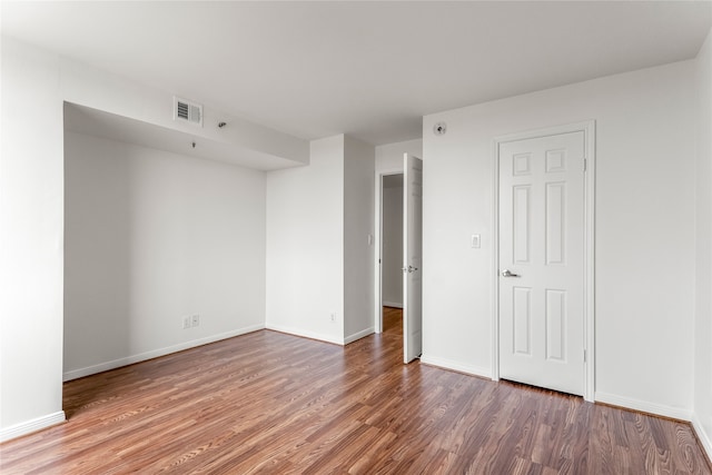 empty room featuring wood-type flooring