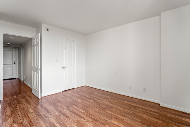 spare room with hardwood / wood-style floors