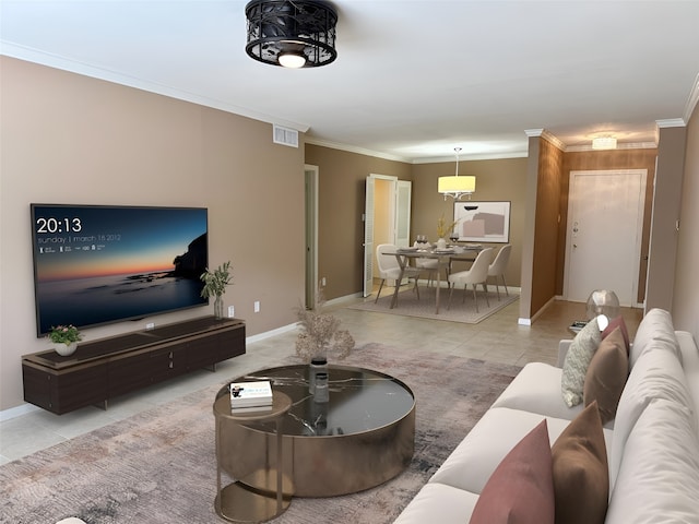 tiled living area featuring visible vents, crown molding, and baseboards