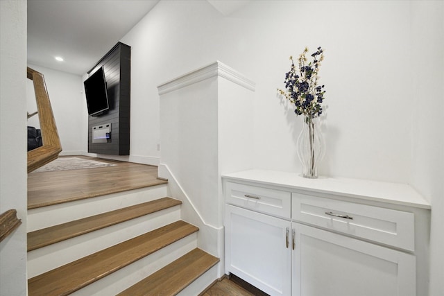 stairs featuring hardwood / wood-style flooring