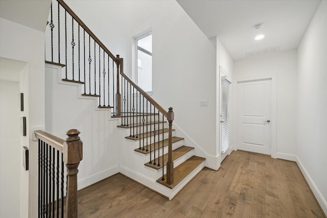 stairs featuring hardwood / wood-style flooring