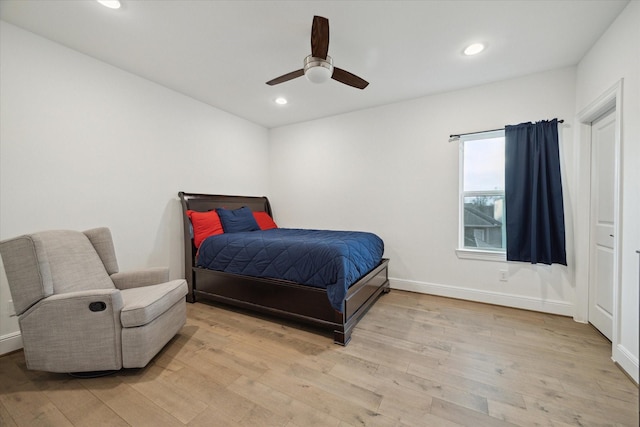 bedroom with ceiling fan and light hardwood / wood-style floors