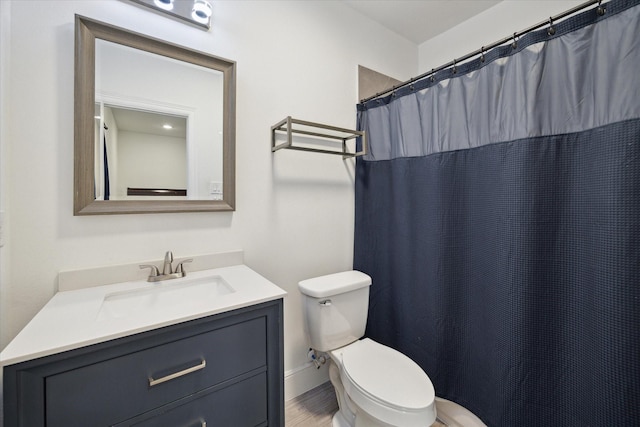 bathroom with toilet and vanity