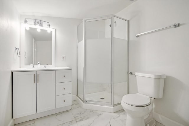 bathroom featuring vanity, a shower with door, and toilet