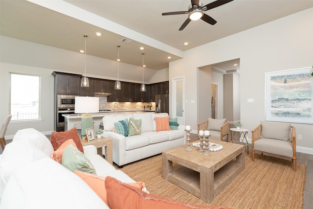 living room with ceiling fan and sink