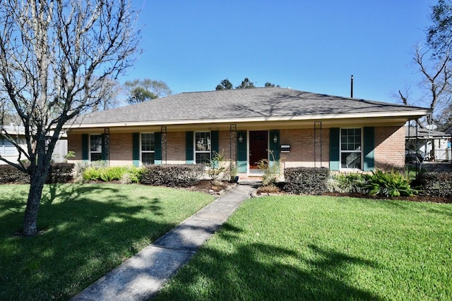 ranch-style home featuring covered porch and a front yard