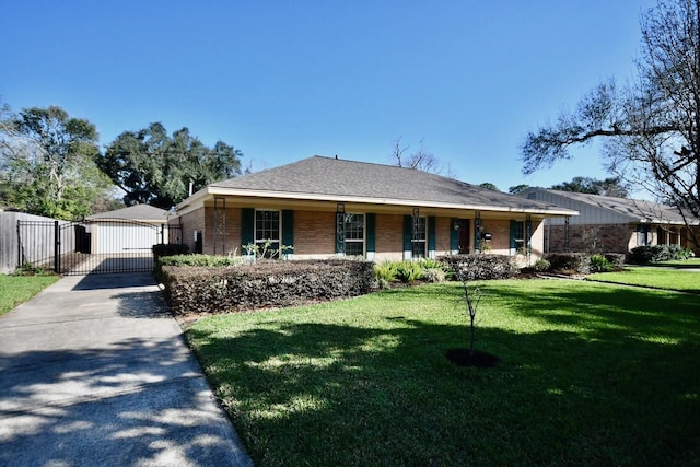 ranch-style home featuring covered porch and a front lawn